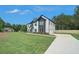 Expansive front lawn leads to this stately home with driveway on right at 110 Northwood Creek Way, Oxford, GA 30054