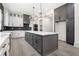 Spacious kitchen featuring a large island, custom cabinets, modern appliances, and stylish pendant lighting at 110 Northwood Creek Way, Oxford, GA 30054