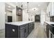 Modern kitchen showcases a large center island and leads to living spaces at 110 Northwood Creek Way, Oxford, GA 30054