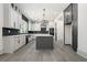 Spacious kitchen with stainless appliances, white cabinets, and a large center island at 110 Northwood Creek Way, Oxford, GA 30054