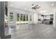 Open floor plan with fireplace, large windows and view of the kitchen at 110 Northwood Creek Way, Oxford, GA 30054