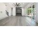 Modern living room featuring an electric fireplace and sliding glass doors at 110 Northwood Creek Way, Oxford, GA 30054