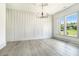 Sunlit living room features stylish wall accents and large windows with backyard views at 110 Northwood Creek Way, Oxford, GA 30054