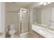 Bathroom featuring single sink, shower with glass door, tile floors and natural light at 1450 Keys Crossing Ne Dr, Brookhaven, GA 30319