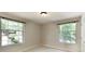 Bedroom featuring carpeted floor and two large windows for natural light at 1450 Keys Crossing Ne Dr, Brookhaven, GA 30319