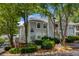 Inviting condo exterior with lush landscaping and a charming, light gray facade and view of the parking area at 1450 Keys Crossing Ne Dr, Brookhaven, GA 30319
