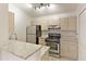 Well-lit kitchen with stainless steel appliances, granite countertops, and a tiled floor at 1450 Keys Crossing Ne Dr, Brookhaven, GA 30319