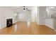 Inviting living room with a fireplace, ceiling fan, and hardwood floors adjacent to an open-concept kitchen at 1450 Keys Crossing Ne Dr, Brookhaven, GA 30319