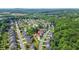 An aerial view showcases a home nestled in a community surrounded by lush greenery and a nearby lake at 200 Cherokee Reserve Cir, Canton, GA 30115