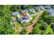 An aerial shot showcases a house with solar panels and a fenced backyard within a well-maintained neighborhood at 200 Cherokee Reserve Cir, Canton, GA 30115