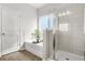 Bathroom with tub and shower, neutral tile, and modern fixtures at 200 Cherokee Reserve Cir, Canton, GA 30115