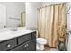 A full bathroom features a vanity with a sink, a toilet, and a shower with a curtain at 200 Cherokee Reserve Cir, Canton, GA 30115