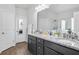 Bathroom featuring dual sinks, granite countertops, and dark cabinets with ample storage at 200 Cherokee Reserve Cir, Canton, GA 30115