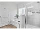 Bright bathroom featuring a bathtub and tiled shower behind glass door at 200 Cherokee Reserve Cir, Canton, GA 30115