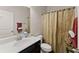 Cozy bathroom with a white sink and a shower behind a curtain at 200 Cherokee Reserve Cir, Canton, GA 30115