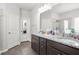A full bathroom features double sinks, a granite countertop, and ample storage space below at 200 Cherokee Reserve Cir, Canton, GA 30115