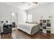 This bedroom features a large bed, stylish decor, and wood flooring at 200 Cherokee Reserve Cir, Canton, GA 30115