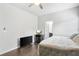 Cozy bedroom with dark wood floors and a comfortable bed next to the ensuite bathroom at 200 Cherokee Reserve Cir, Canton, GA 30115