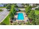 A clear aerial shot showcases a community pool surrounded by lounge chairs and greenery in a neighborhood at 200 Cherokee Reserve Cir, Canton, GA 30115