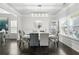 Formal dining room with hardwood floors, chandelier, large windows, and seating for six at 200 Cherokee Reserve Cir, Canton, GA 30115