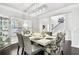 Bright dining room features a modern chandelier, hardwood floors, and views of the outdoors at 200 Cherokee Reserve Cir, Canton, GA 30115