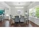 Dining room with modern chandelier, large windows, and dark wood floors at 200 Cherokee Reserve Cir, Canton, GA 30115