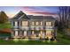 Beautiful two story home with manicured lawn and elegant exterior lighting, featuring a covered front porch at 200 Cherokee Reserve Cir, Canton, GA 30115