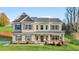 Beautiful two story home with manicured lawn, featuring a covered front porch and neutral siding at 200 Cherokee Reserve Cir, Canton, GA 30115