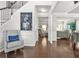 Welcoming foyer showcasing hardwood floors, a staircase, and seamless flow into the living area at 200 Cherokee Reserve Cir, Canton, GA 30115