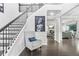 Grand foyer boasts hardwood floors, staircase with iron railings, and elegant decor at 200 Cherokee Reserve Cir, Canton, GA 30115