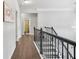 Hallway with hardwood floors offers easy access to the bathroom and other rooms at 200 Cherokee Reserve Cir, Canton, GA 30115