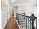 Upstairs hallway with hardwood floors, neutral paint, and views of other rooms at 200 Cherokee Reserve Cir, Canton, GA 30115