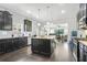 Open kitchen featuring dark cabinetry, granite countertops, stainless steel appliances, and hardwood flooring at 200 Cherokee Reserve Cir, Canton, GA 30115