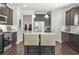 Well-equipped kitchen boasting stainless steel appliances, dark cabinets, a center island with seating at 200 Cherokee Reserve Cir, Canton, GA 30115