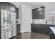 Modern kitchen with dark cabinets, stainless steel appliances, granite counters, and hardwood floors at 200 Cherokee Reserve Cir, Canton, GA 30115