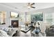 Cozy living room with fireplace, large windows, hardwood floors, and stylish furniture at 200 Cherokee Reserve Cir, Canton, GA 30115
