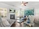 Cozy living room with a fireplace, hardwood floors, and large windows offering natural light at 200 Cherokee Reserve Cir, Canton, GA 30115