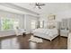 Spacious main bedroom with a tray ceiling, light-colored walls, and hardwood floors at 200 Cherokee Reserve Cir, Canton, GA 30115
