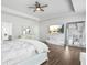 Open main bedroom with hardwood floors, TV, large mirror, and neutral tones at 200 Cherokee Reserve Cir, Canton, GA 30115