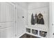Well-organized mudroom with built-in bench, coat hooks, and storage baskets for shoes and accessories at 200 Cherokee Reserve Cir, Canton, GA 30115