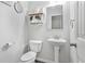 Elegant powder room with pedestal sink, decorative mirror, and stylish shelving for decor at 200 Cherokee Reserve Cir, Canton, GA 30115