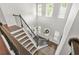 Grand foyer with staircase and abundant natural light from large windows at 200 Cherokee Reserve Cir, Canton, GA 30115