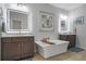 Elegant bathroom featuring double vanities, soaking tub, and stylish LED mirrors and hardware at 421 Retreat Ln, Canton, GA 30114