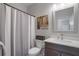 Well-lit bathroom with a shower, toilet, vanity, framed mirror and neutral decor at 421 Retreat Ln, Canton, GA 30114