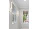 Bright foyer with a white front door, modern lighting, and view of the manicured neighborhood at 421 Retreat Ln, Canton, GA 30114