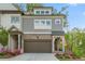 Charming townhome with a brick and gray shingle exterior, complemented by a two-car garage and colorful landscaping at 421 Retreat Ln, Canton, GA 30114