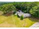 Aerial view of a home with a pool, large yard, and plenty of trees at 1050 Denton Rd, Douglasville, GA 30134