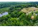 Aerial view of the property showing the surrounding roads, large pond, and wooded area at 1050 Denton Rd, Douglasville, GA 30134