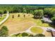 Picturesque aerial view of a sprawling property with mature trees and landscaping at 1050 Denton Rd, Douglasville, GA 30134