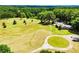 Lush greenery surrounds a home with mature trees, expansive lawns, and a circle driveway at 1050 Denton Rd, Douglasville, GA 30134